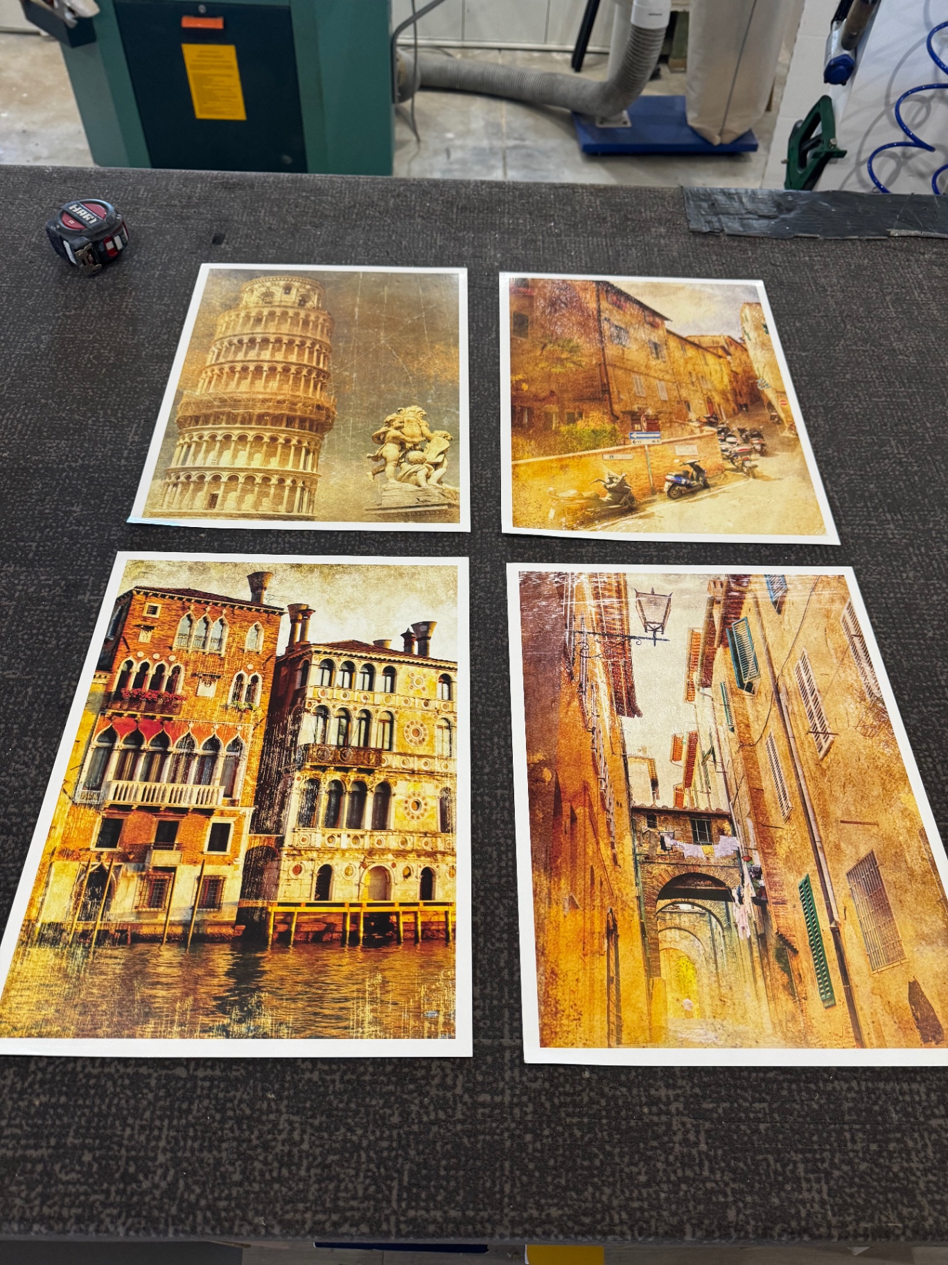 Italian travel art prints on the studio workbench