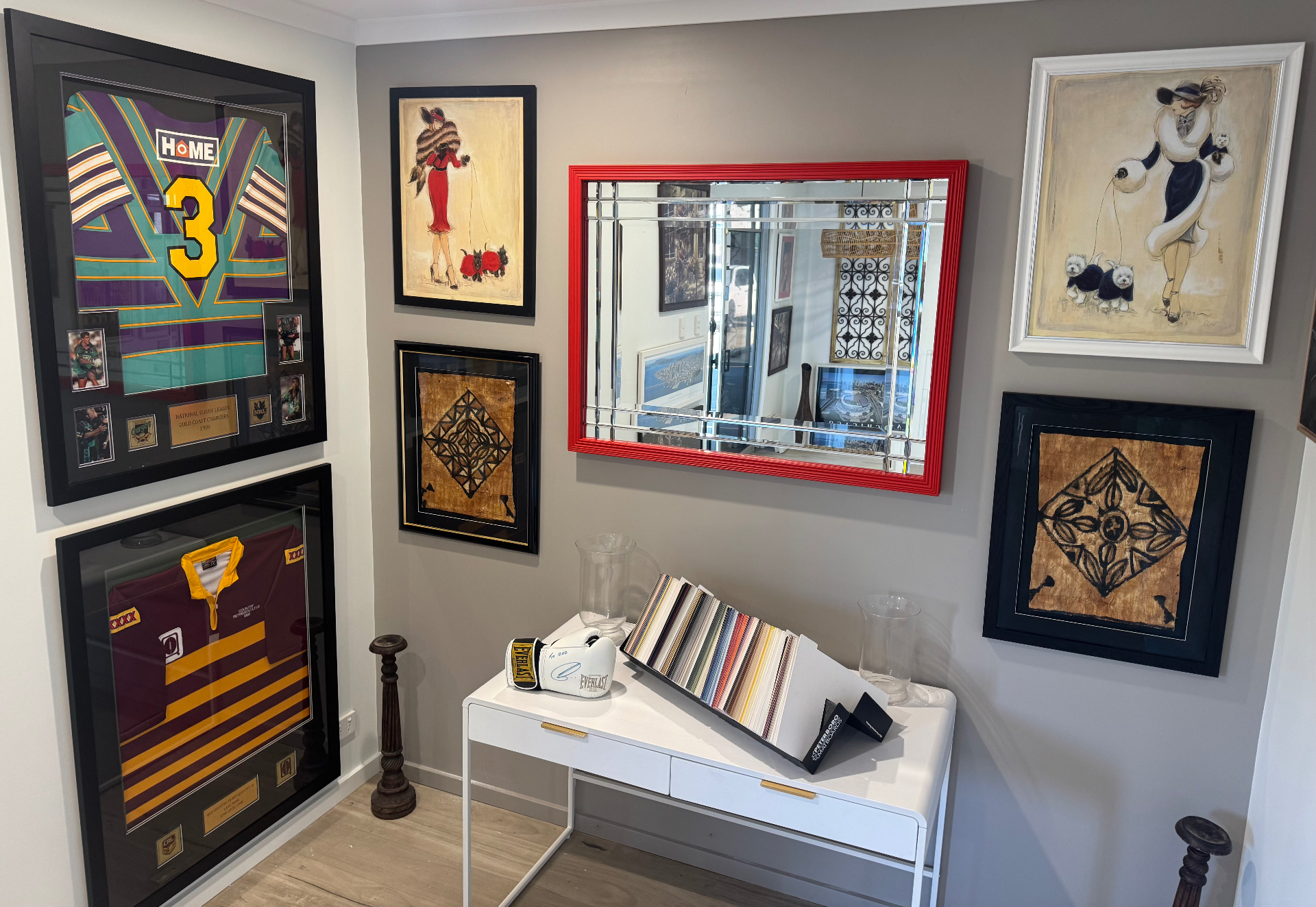 Studio interior with framed jerseys, artwork and frame samples