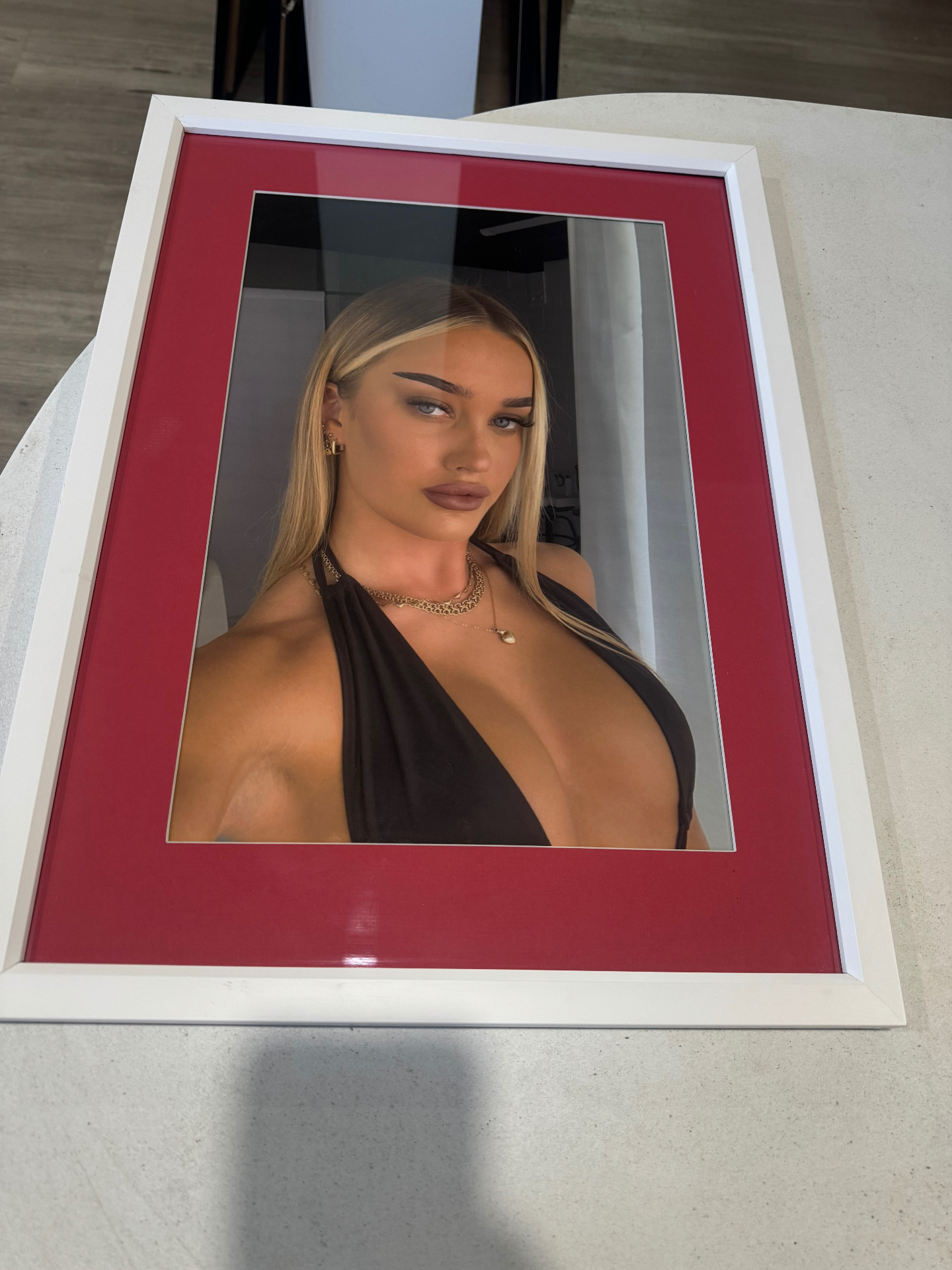 Framed portrait photograph with red mat and white frame