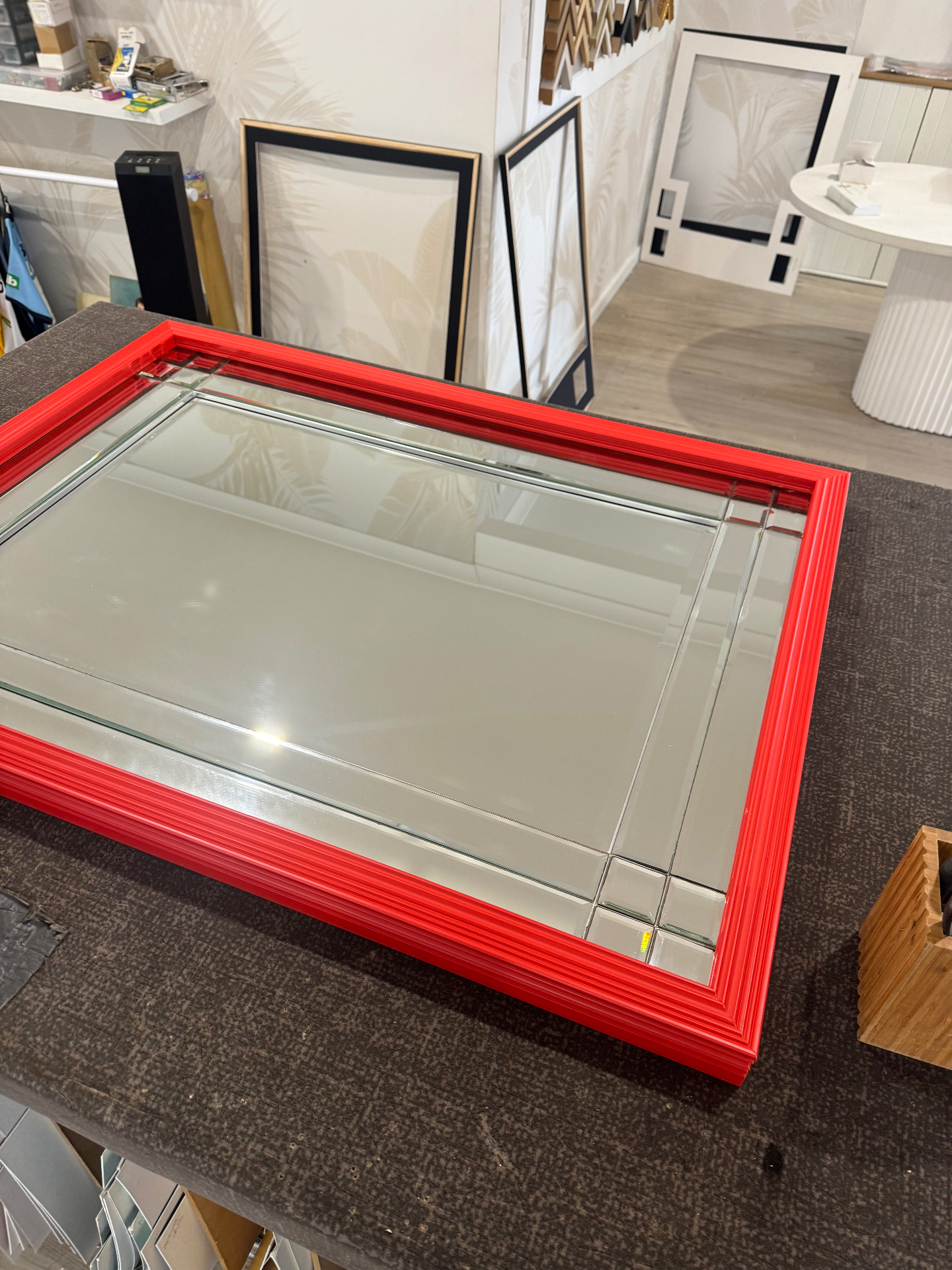 Custom red framed mirror with bevelled glass panels